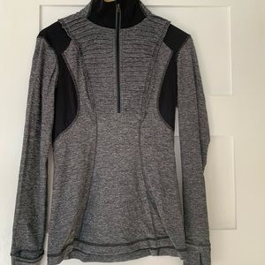 Lululemon ruffle pull-over with zipper pocket.